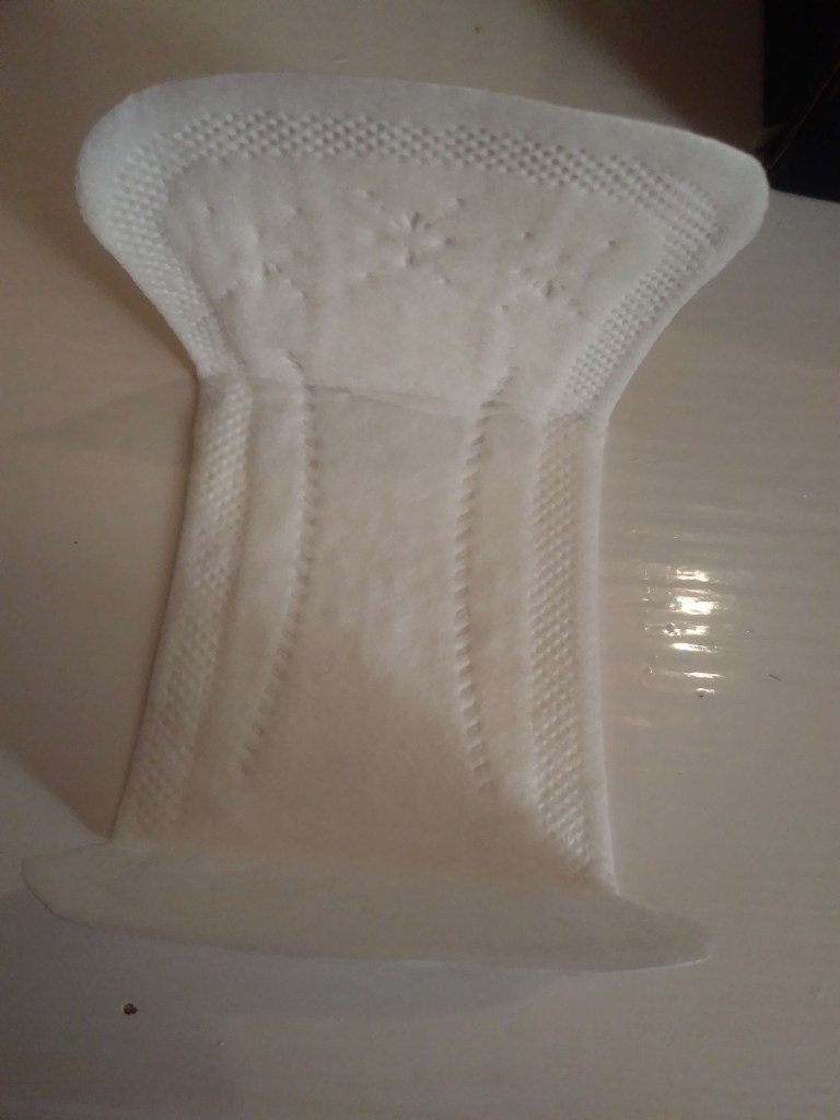 Small, white, unwrapped Bodico panty liner, displayed frontways. 