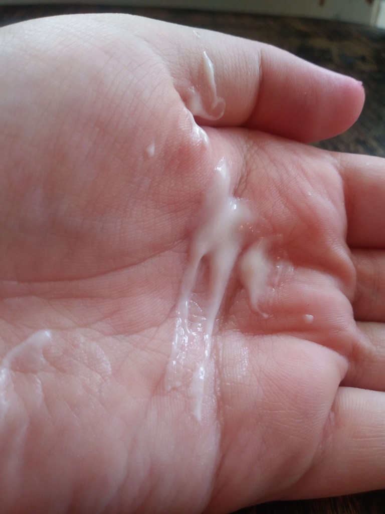 White St. Ives lotion on a pale hand.